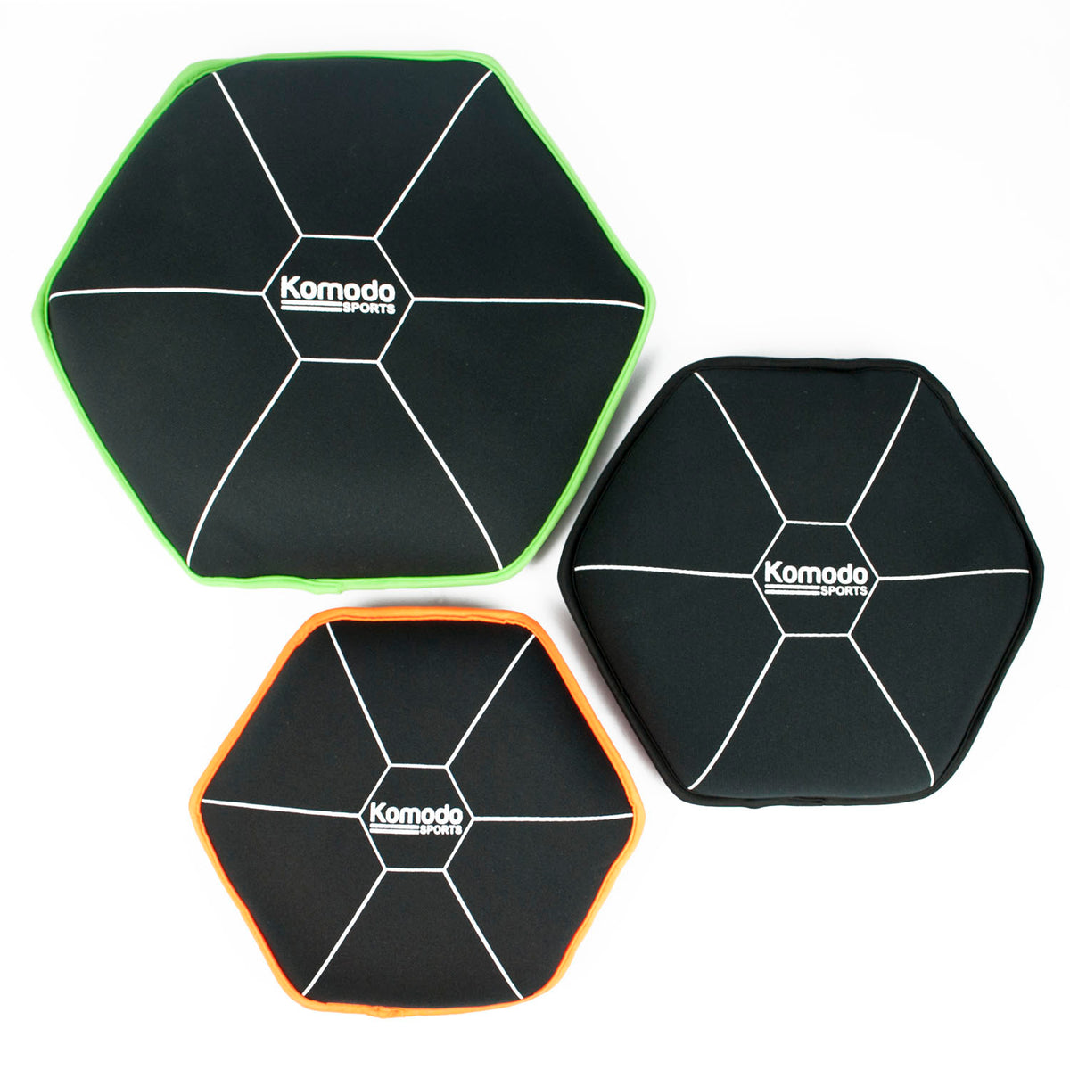 Three black hexagonal sandbags with green and orange borders on a white background, featuring the Komodo brand.