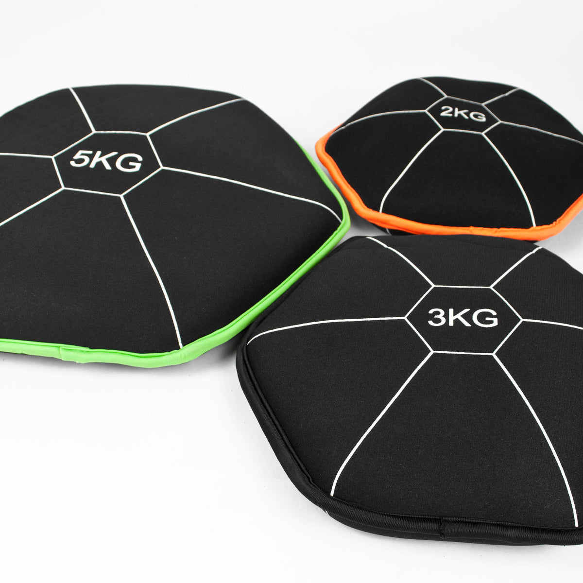 Three black hexagonal weight bags for gym storage, labeled 5KG, 3KG, and 2KG, arranged on a white background. The bags have white lines and are accented with bright green, orange, and white trim.