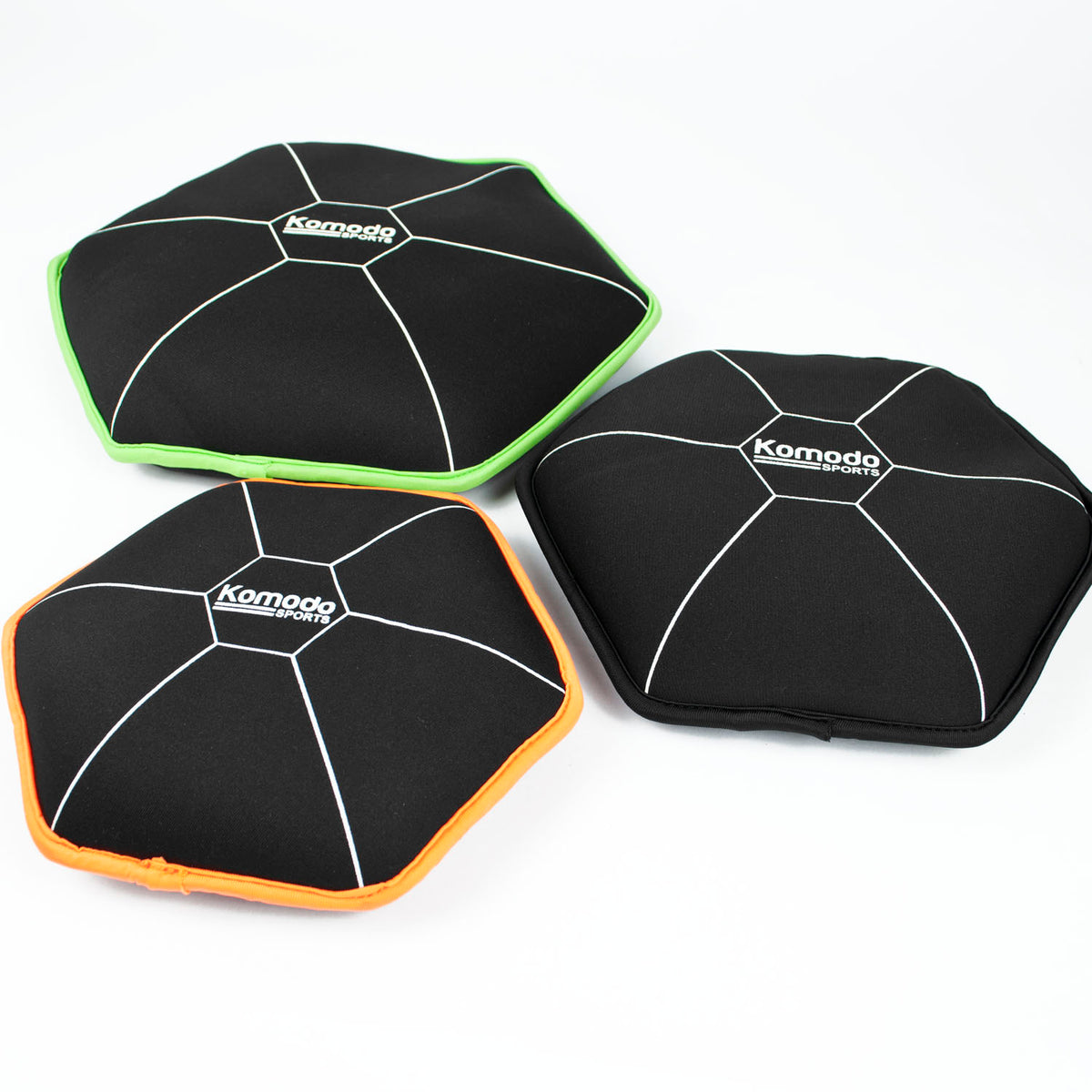 Three Komodo Hexagon Fitness weight plates in black neoprene with white printed lines and coloured borders, shown on a white background.