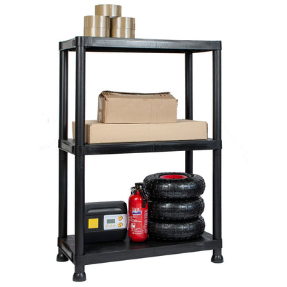 A three-tier black plastic utility storage shelf with legs, shown on a white background and stocked with boxes, tires, and a fire extinguisher.