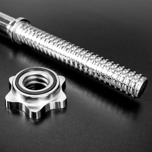 A close-up studio shot of a metallic threaded rod and a matching star-shaped bearing on a dark reflective surface.