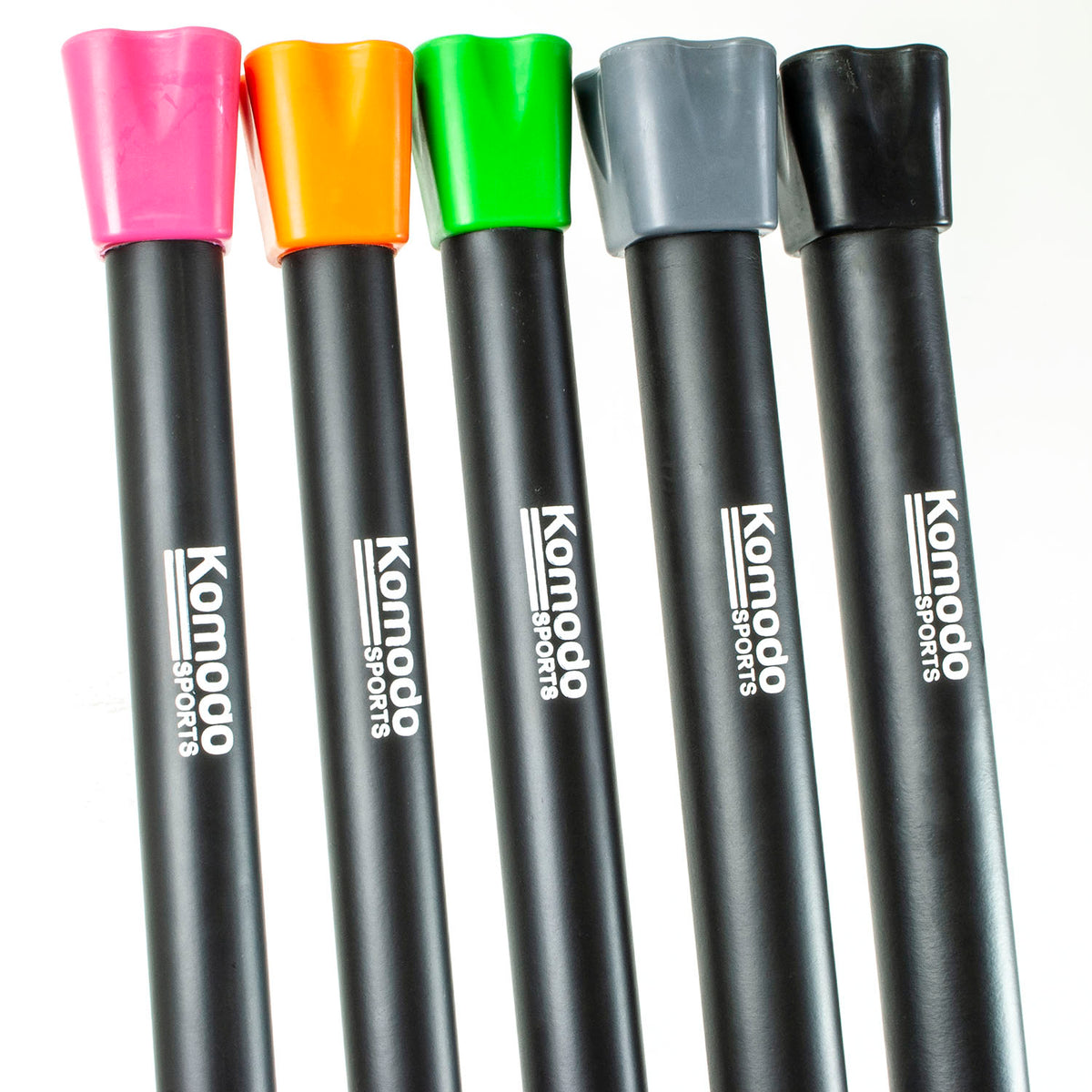 Five Komodo Sports weighted bars with black bars and colorful caps in pink, orange, green, gray, and black, arranged vertically on a white background.