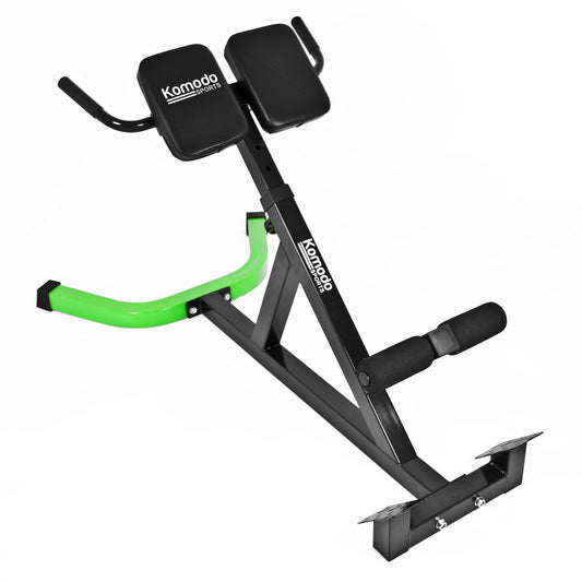 A black and green Komodo Fitness abdominal exercise machine with a dual-pad backrest, footrest, and curved handlebar, shown on a plain white background.