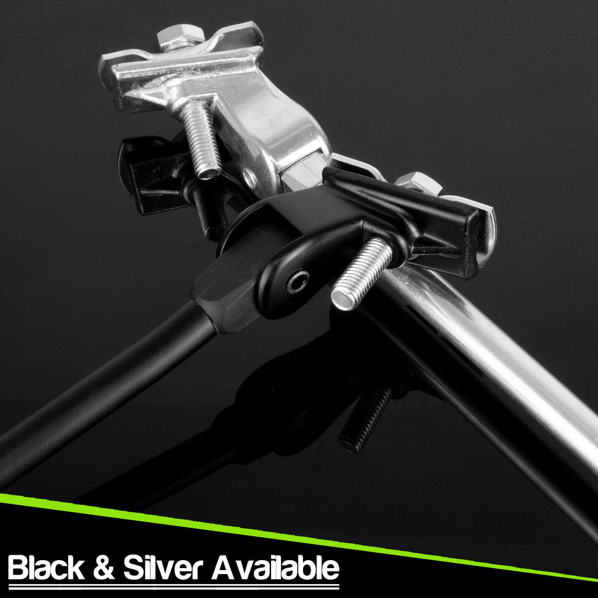 Close-up of a metal bike kick stands with black and silver components on a dark reflective background, with text at the bottom reading 'Black & Silver Available'.