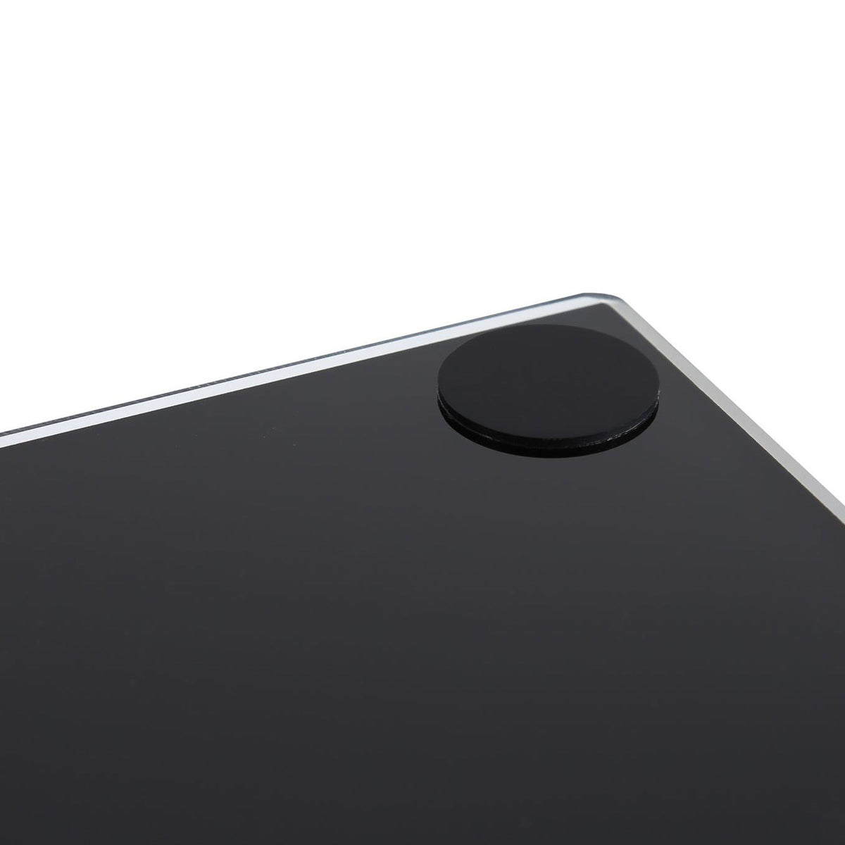 Close-up of the top corner of a black glossy tablet or smartphone showing a circular black camera cutout and a thin silver edge against a white background.