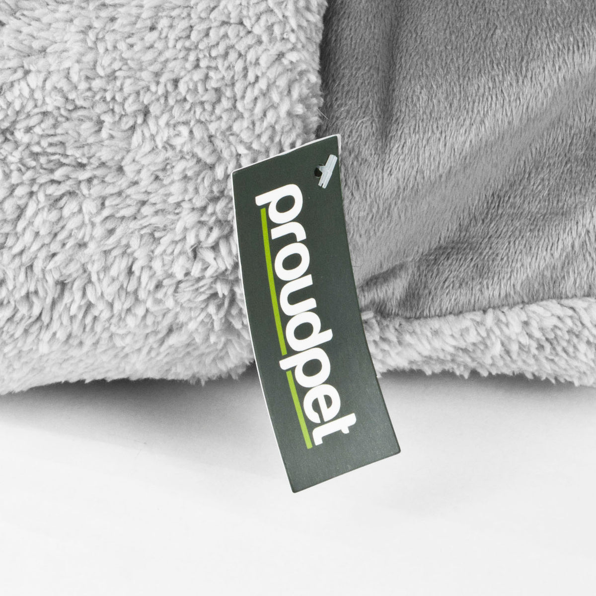 Gray cat bed with a 'proudpet' tag on a white background