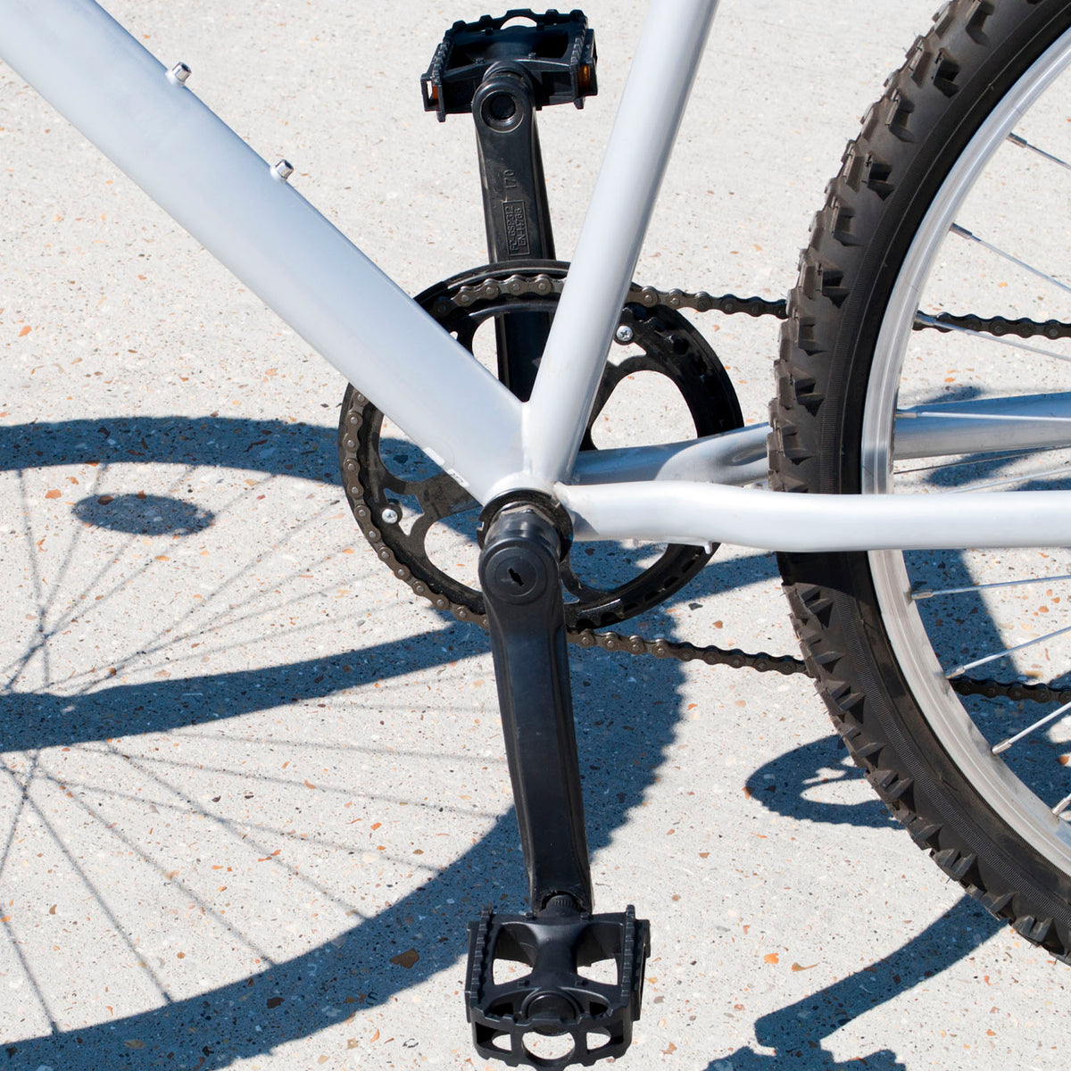 Standard 9/16" Bicycle Pedals Pair - Plastic on a bicycle, shown outside.