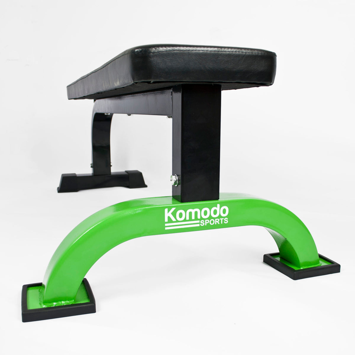 Green and black exercise bench with 'Komodo Sports' branding on a white background
