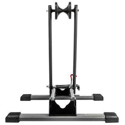 A black indoor cycling holder with a rear wheel mount and bottom bracket, shown against a solid white background.