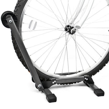 A black metal bicycle wheel stand holding a rear bicycle wheel against a clean white background.