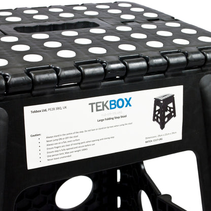 Close-up of a black TEKBOX large folding step stool with a white product information label attached to the side, showing the brand name and product details.