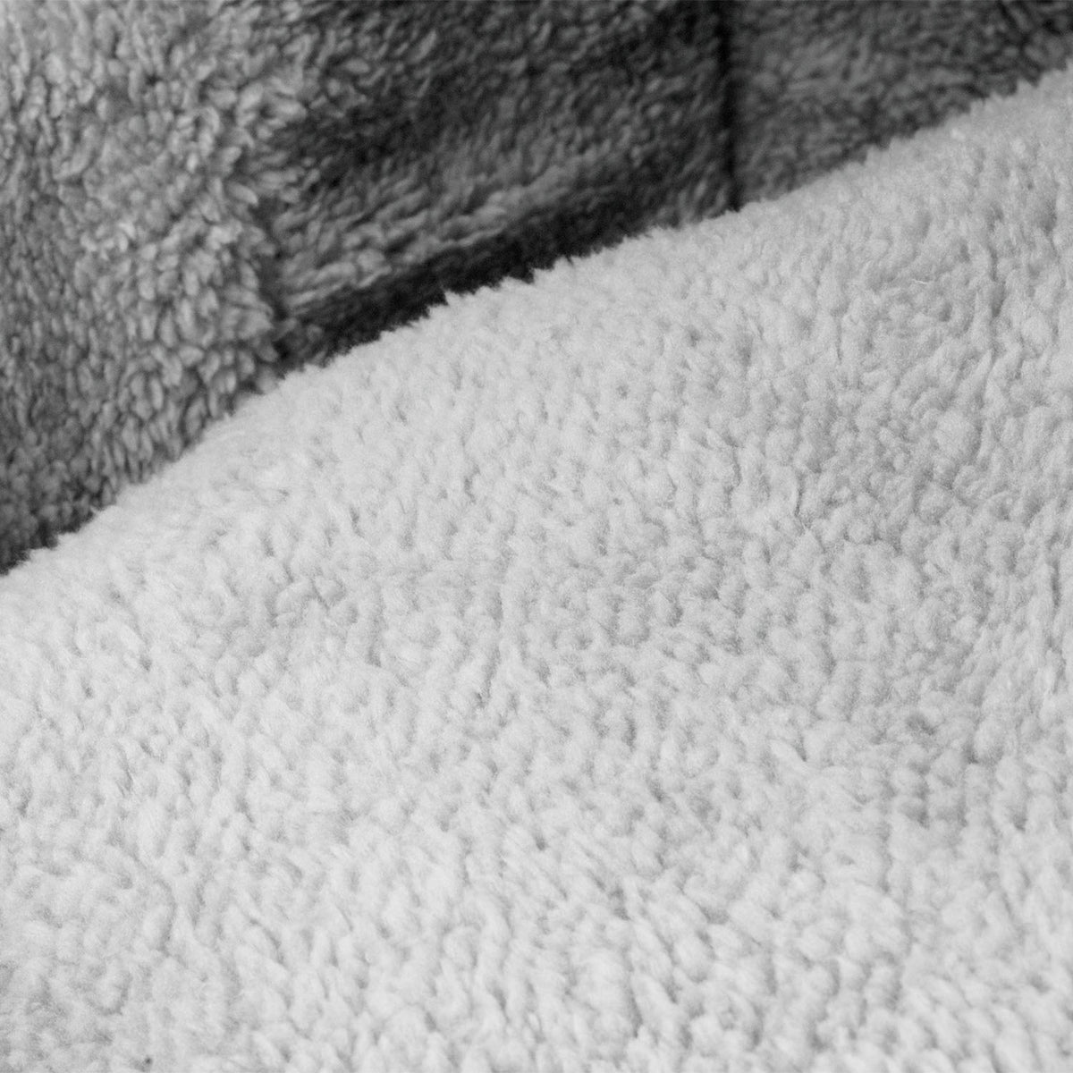 Close-up of a soft, plush fleece or sherpa fabric in a light gray color, showing the textured looped material. Inside of a cat igloo.