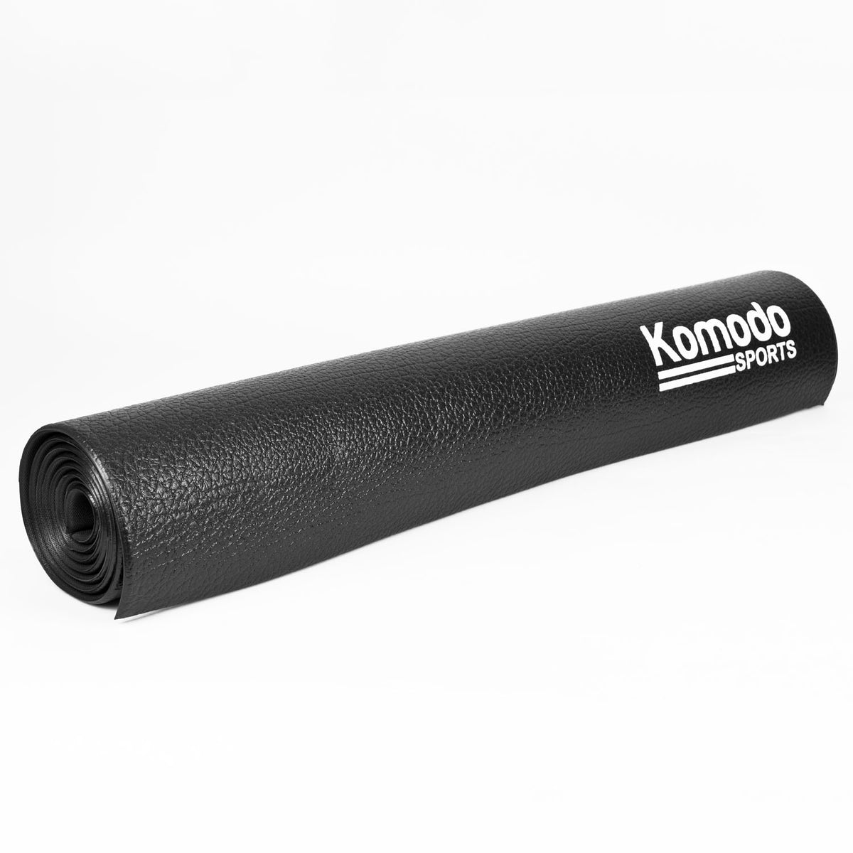 A rolled-up black textured floor mat with the brand name 'Komodo SPORTS' printed in white on the side, set against a plain white background.