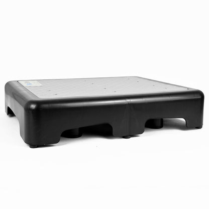 A black plastic step platform with a textured top surface and raised side walls, shown on a plain white background.