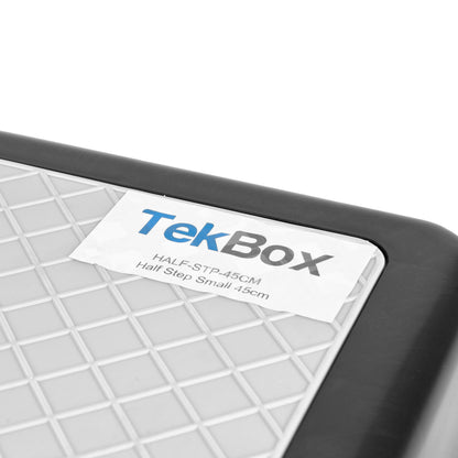Close-up of a TekBox Half Step Small 45cm label with a grey grid surface, black frame, and a white label showing the TekBox branding.