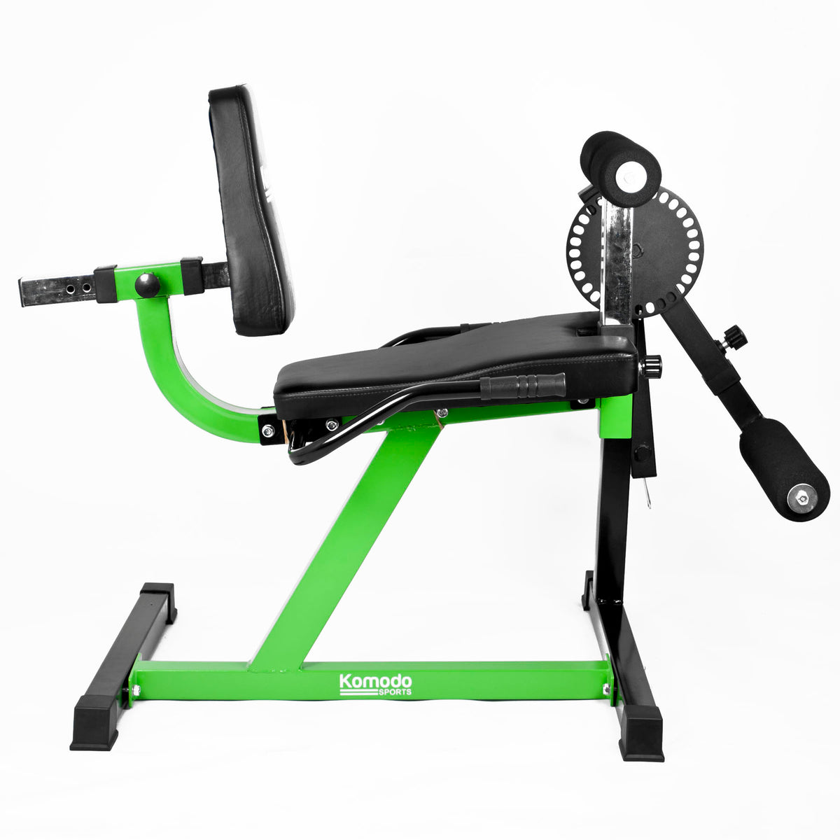A Komodo brand leg extension exercise machine with a bright green frame and black padded components, shown from a three-quarters angle on a white background.