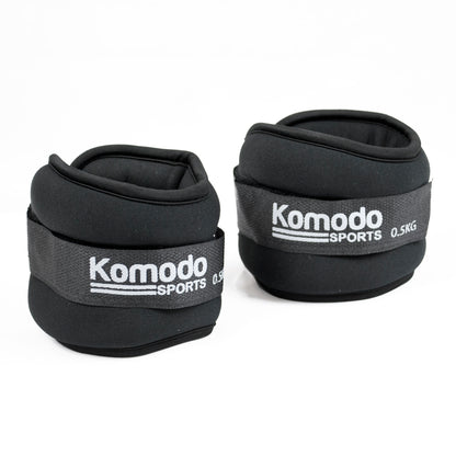 A pair of black Komodo Sports 0.5kg ankle weights on a clean white background.