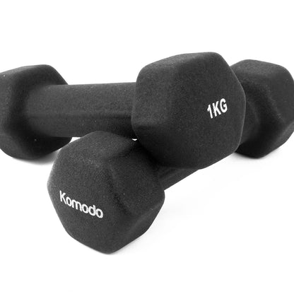 Two black neoprene dumbbells stacked together on a white background, with one dumbbell showing the brand name 'Komodo' and the other showing '1KG'.