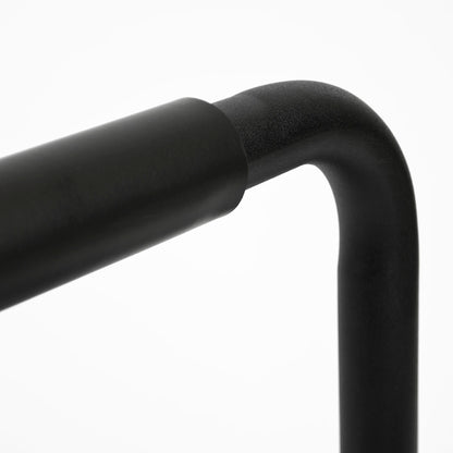 Close-up of a matte black metal frame corner with a curved arm and vertical post on a white background.