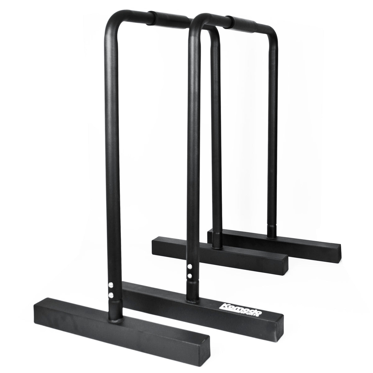 Black metal parallel bar exercise equipment with a white 'Komodo' brand logo on the front base, shown against a plain white background.