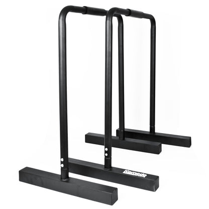 Black metal parallel bar exercise equipment with a white 'Komodo' brand logo on the front base, shown against a plain white background.