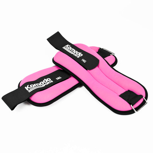 Pink ankle weights with black straps and 'Komodo Sports' branding on a white background