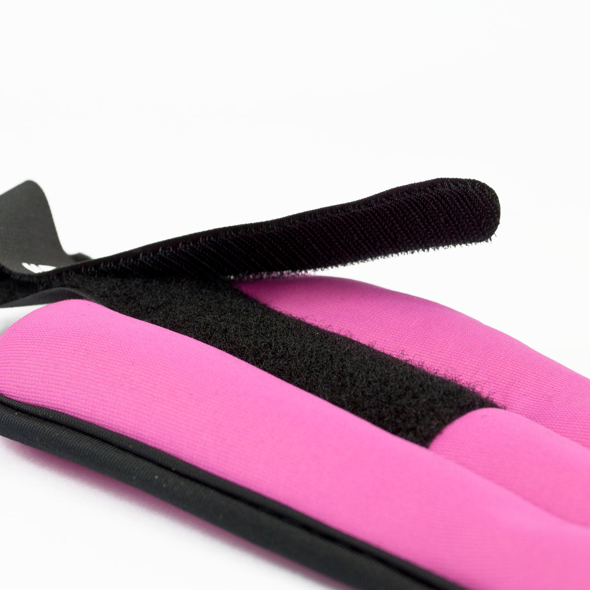 Pink and black ankle weights on a white background