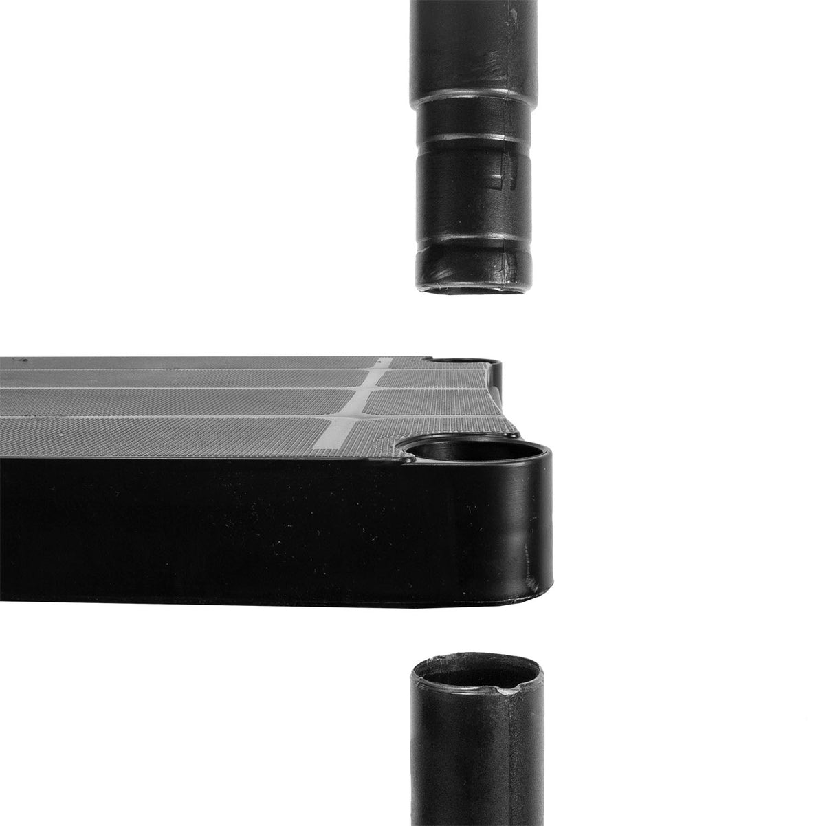 Close-up of a black rectangular panel with a circular opening, shown disassembled with two matching black cylindrical pieces floating above and below on a white background.