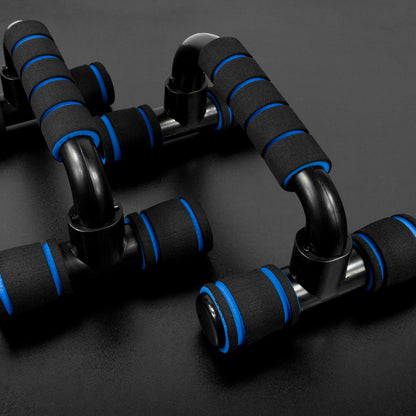 Black adjustable push-up bars with blue foam grip accents, arranged on a dark gray surface.