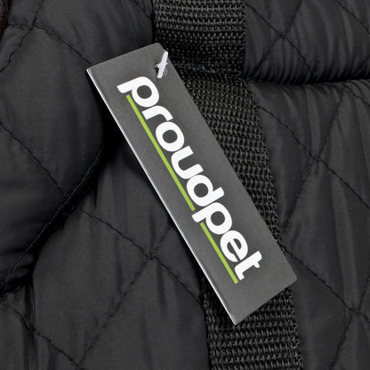 A close-up of a black quilted dog carrier with a black woven strap and a hanging tag that reads 'proudpet' in white with a green underline.