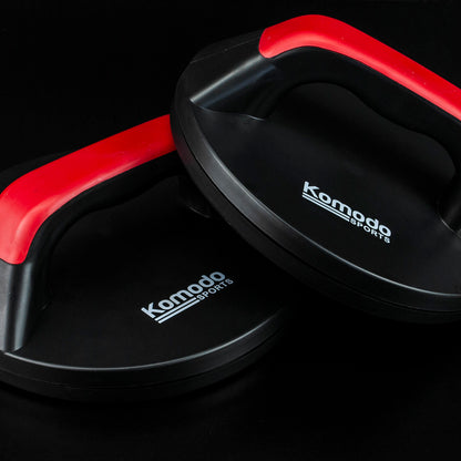 Two black Komodo Sports push-up boards with red bars, shown overlapping on a black background.