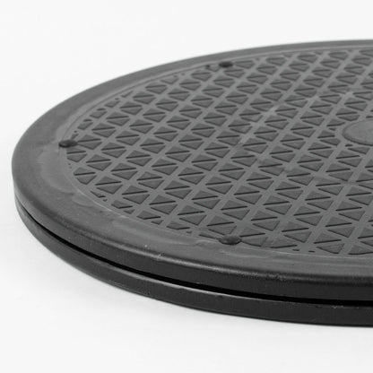A close-up of a rotating platform with a raised border and a repeating triangular pattern, photographed on a plain white background.