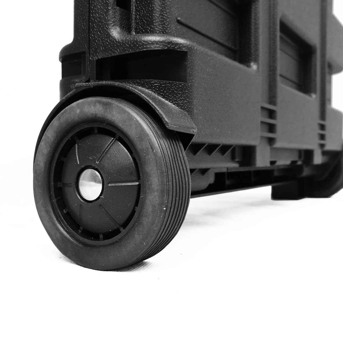 Close-up of a black wheeled shopping trolley box with a textured plastic body and a black wheel, shown on a white background.