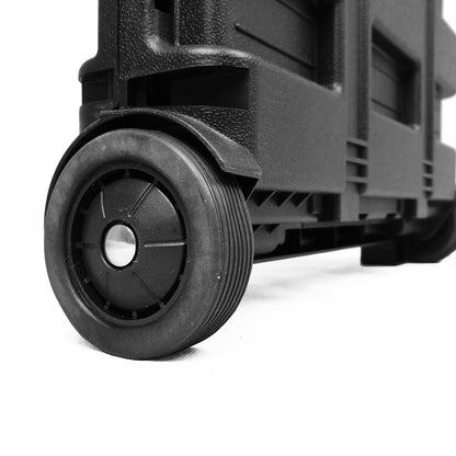 Close-up of a black wheeled shopping trolley box with a textured plastic body and a black wheel, shown on a white background.