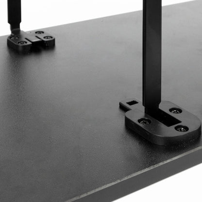 Close-up of a black monitor riser with metal support legs and mounting brackets on a white background.