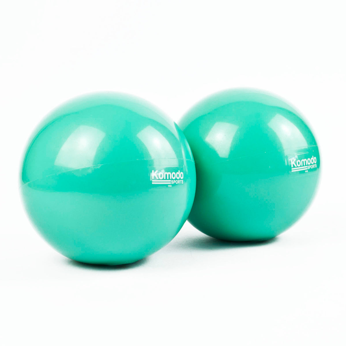 Two green Komodo Weighted Toning Balls placed side by side. on a white background.