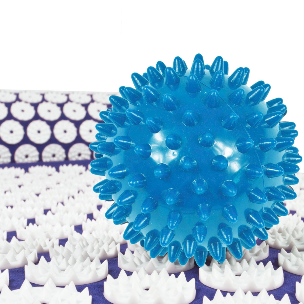 Blue muscle relaxation mat with pillow and massage ball set displayed on a white surface with travel bag nearby