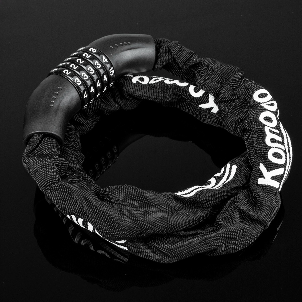 Close-up of a resettable bike lock showing the 5 digit combination on a heavy duty steel chain with fabric cover