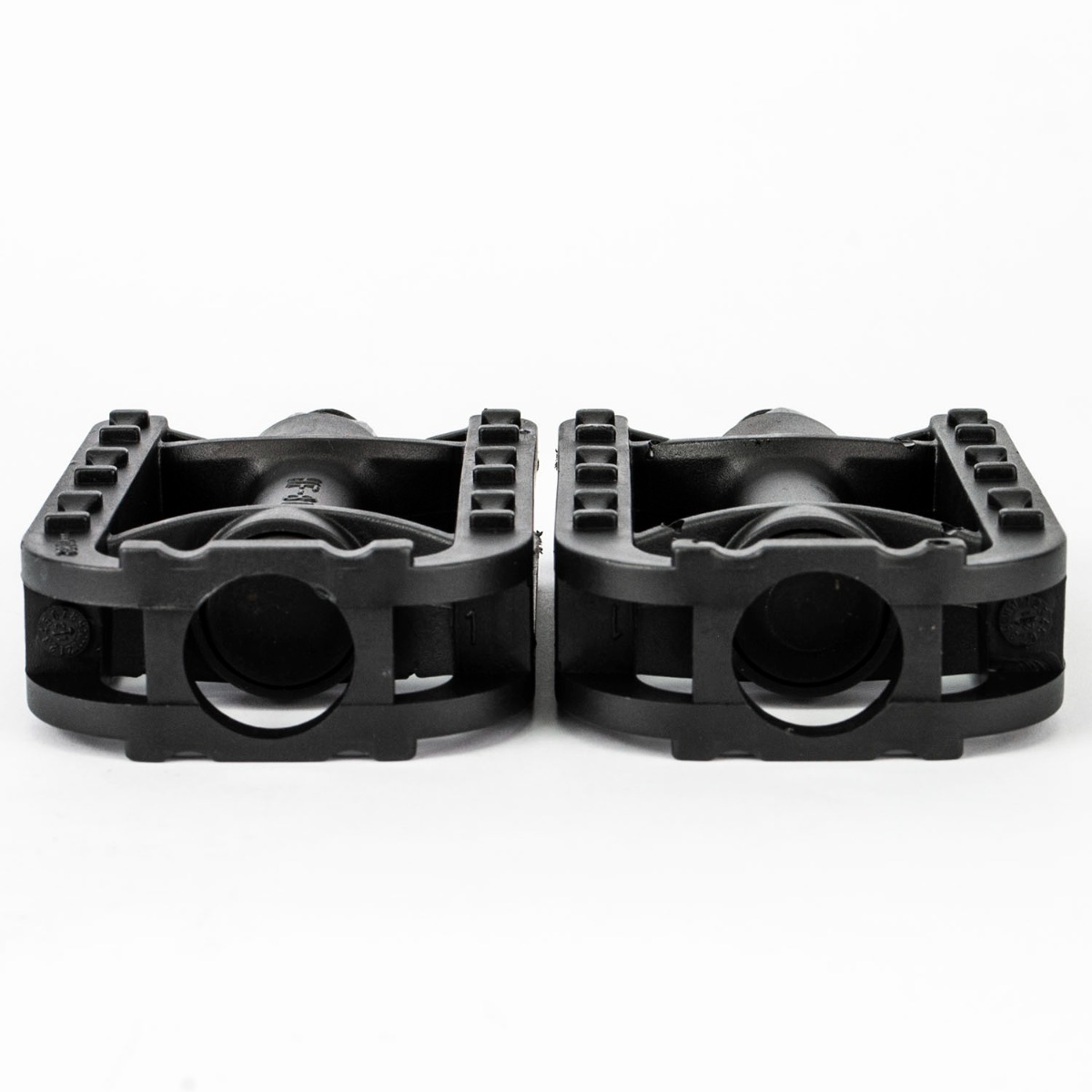 Black ABS plastic bike pedals for kids' bikes with reflectors on each side for visibility in low light conditions