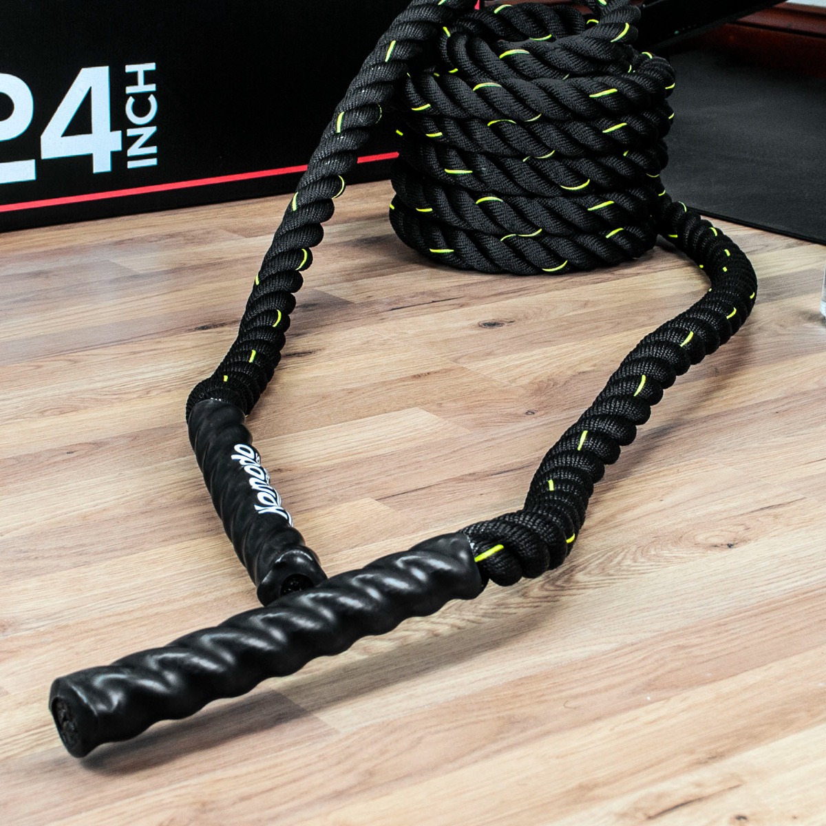 9 metre battle rope coiled on floor with thick 38mm diameter and coated handles for full body gym workout