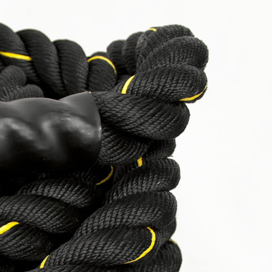 9 metre Komodo gym battle rope coiled on floor, ready for intense battle rope workout sessions at home or gym