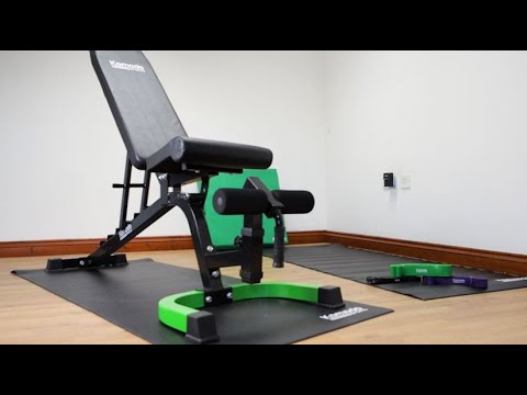 Shock resistant gym mat under bike trainer and gym bench, protecting floor and reducing vibrations during workouts