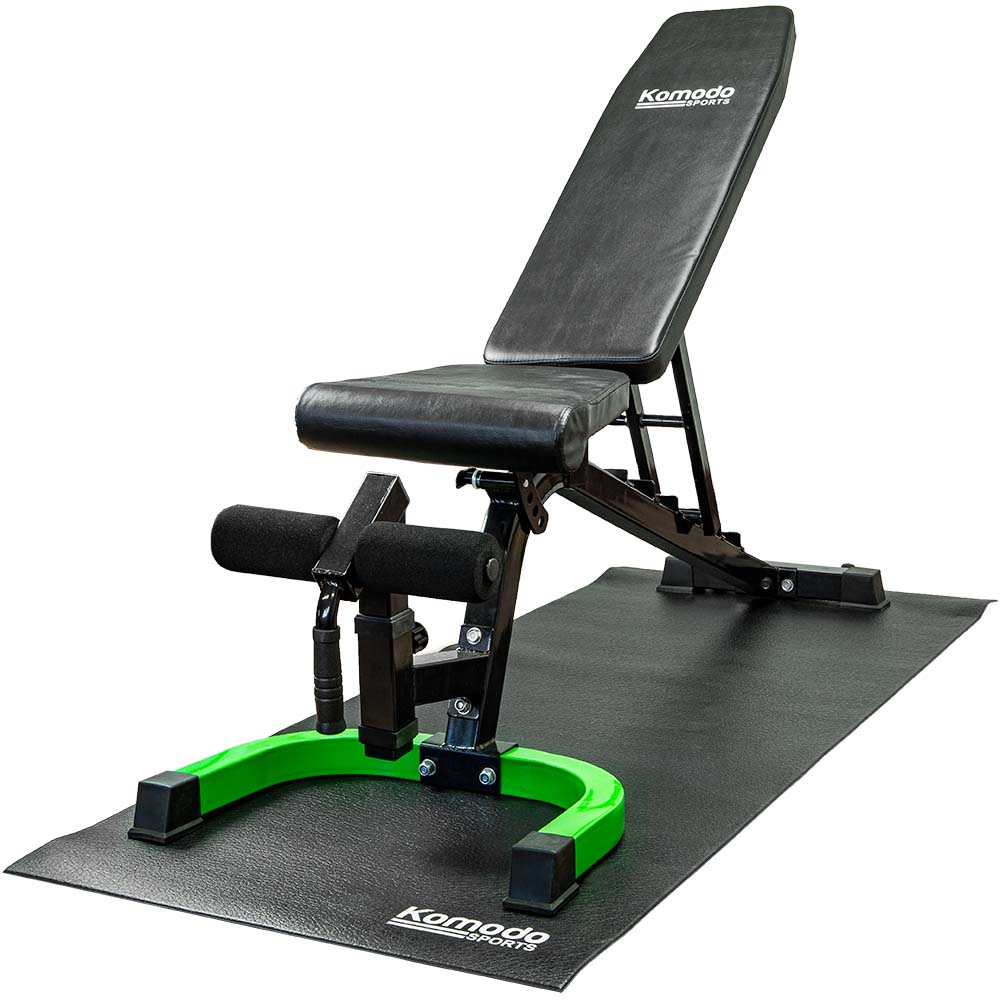 Black cushioned exercise equipment mat under gym bench and bike trainer, protecting floor and reducing vibrations