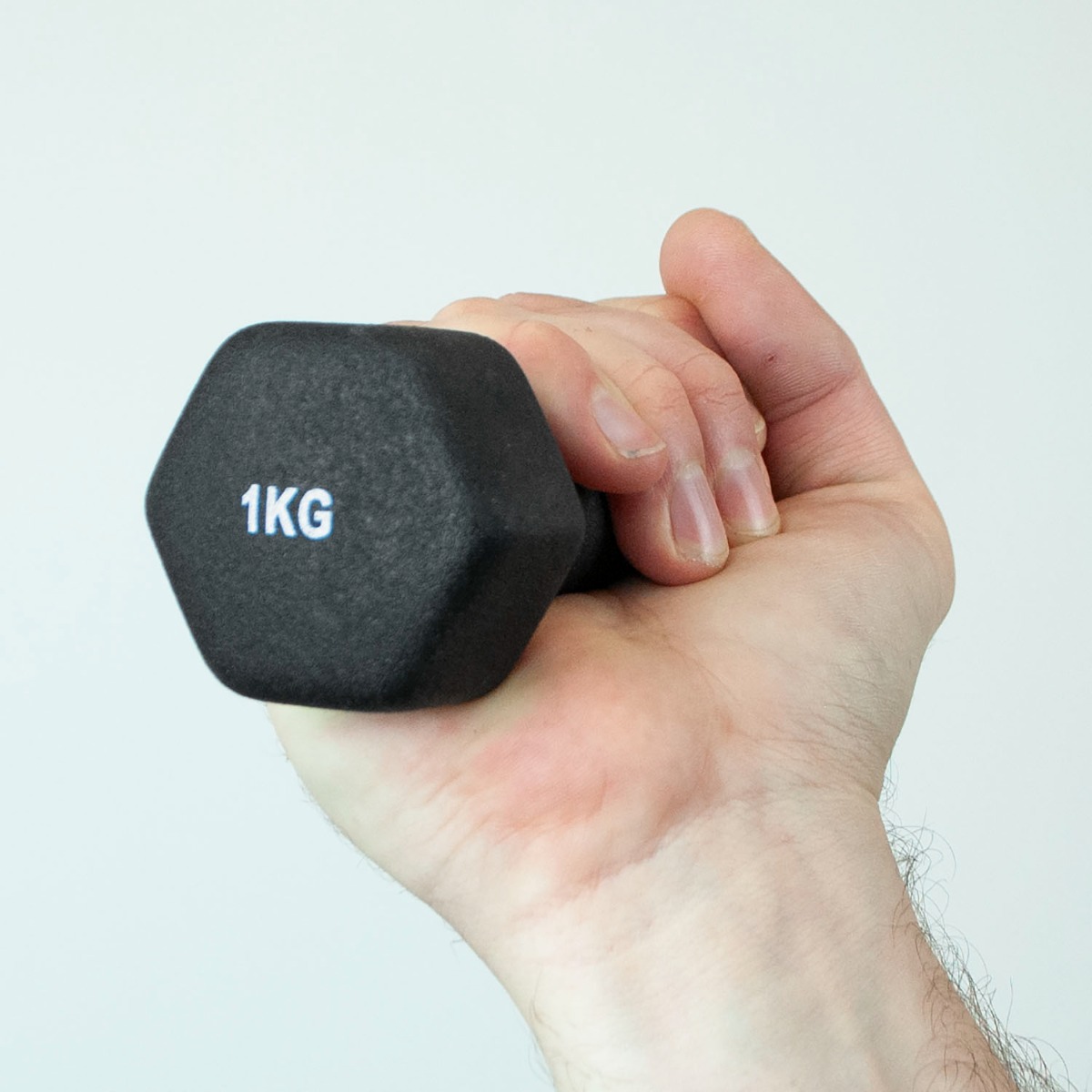 Pair of 1kg iron core dumbbells with black neoprene coating for grip, shown on a white background