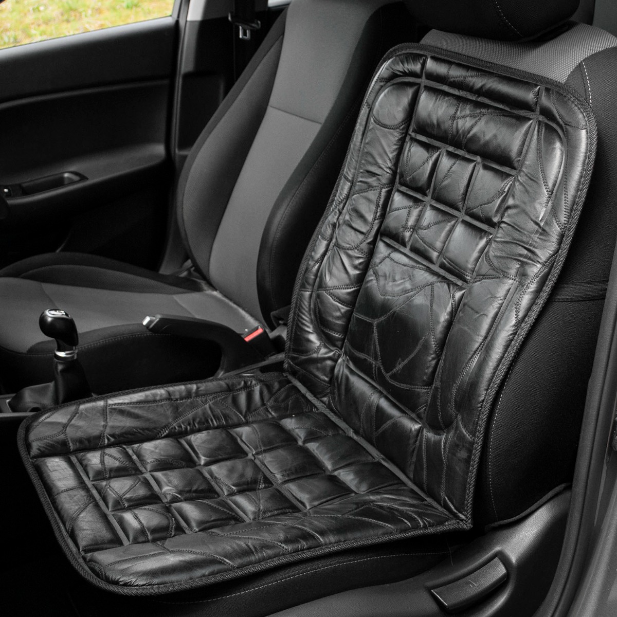 Pair of black leather car seat covers with padded foam, designed for orthopaedic comfort and easy installation
