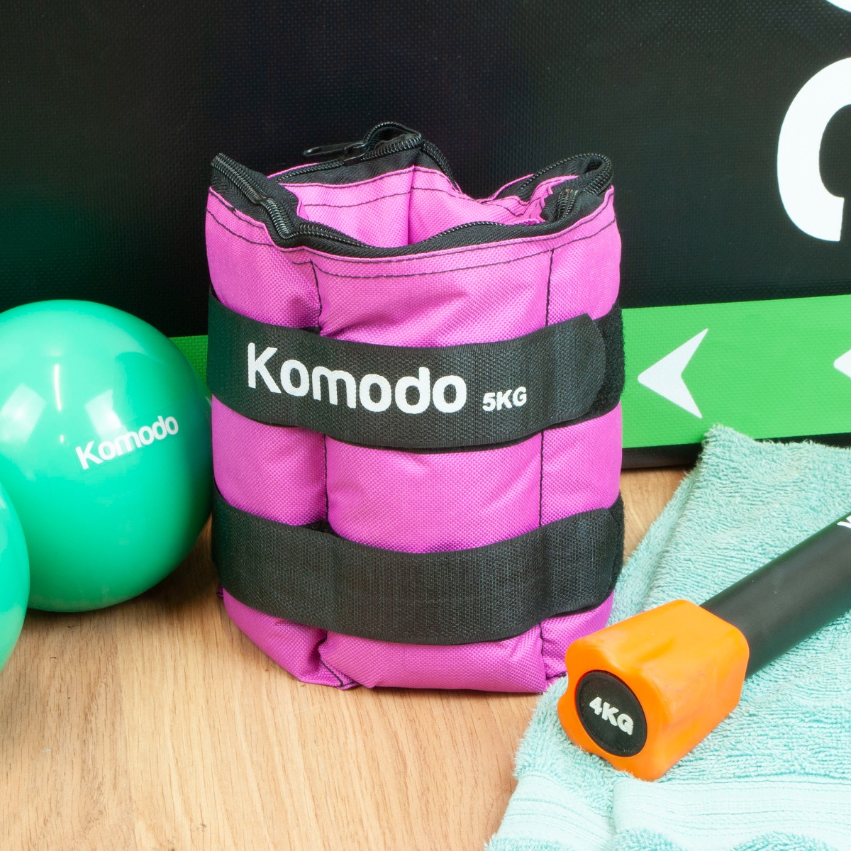 Pink adjustable wrist and ankle weights with secure straps, total max weight 10kg, designed for exercise resistance and toning