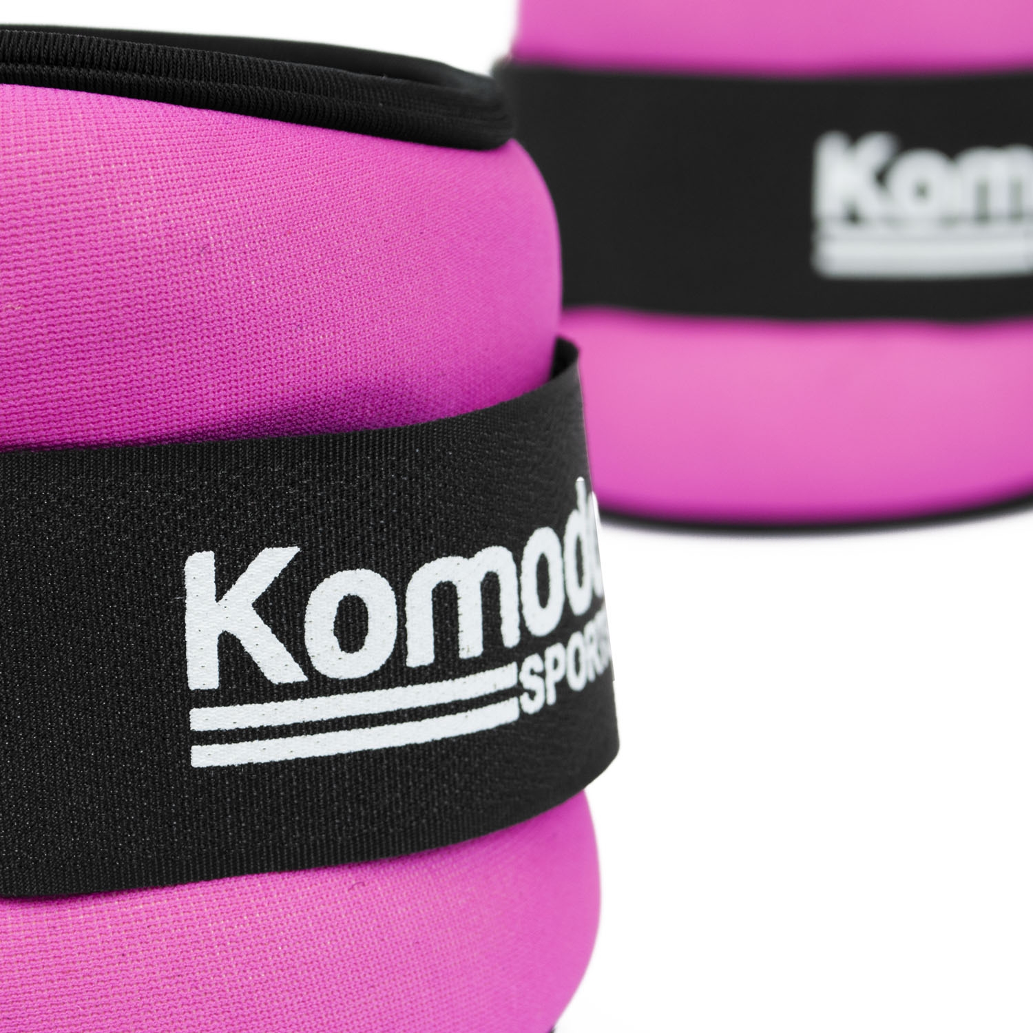 Pair of pink neoprene ankle weights with adjustable velcro straps displayed on a white background