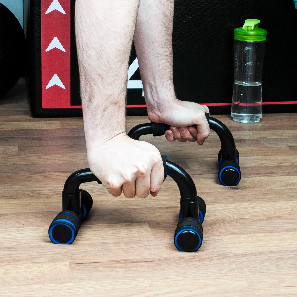 Pair of blue pp plastic push up bars with foam grips on a white background showing ergonomic design