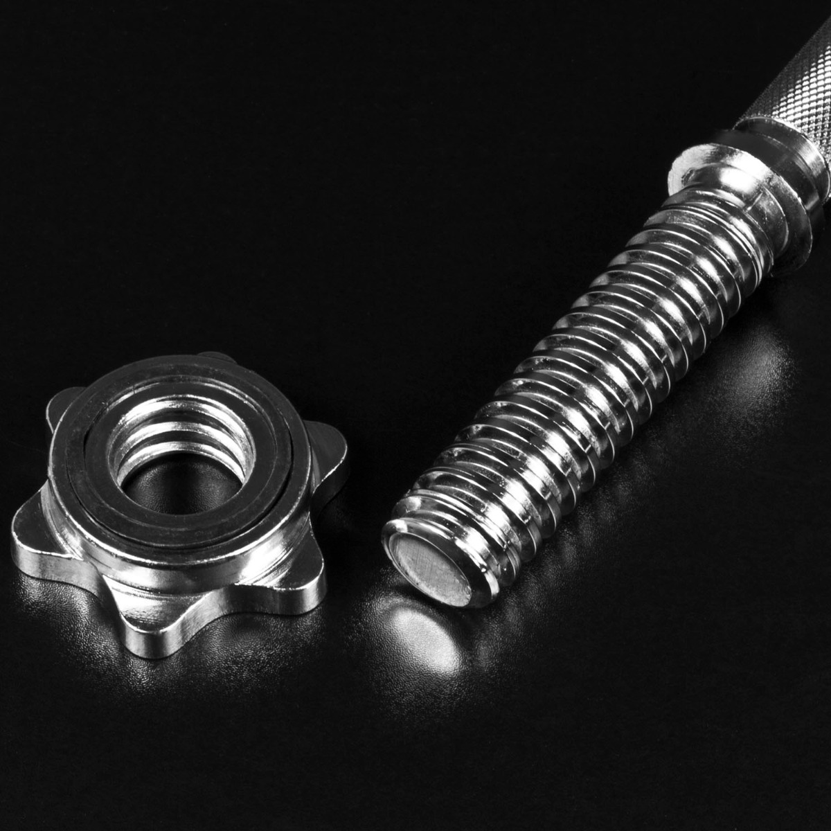 Spinlock dumbbell bars pair with chrome finish, knurled grip, and spinlock collars securing the weights on both ends.