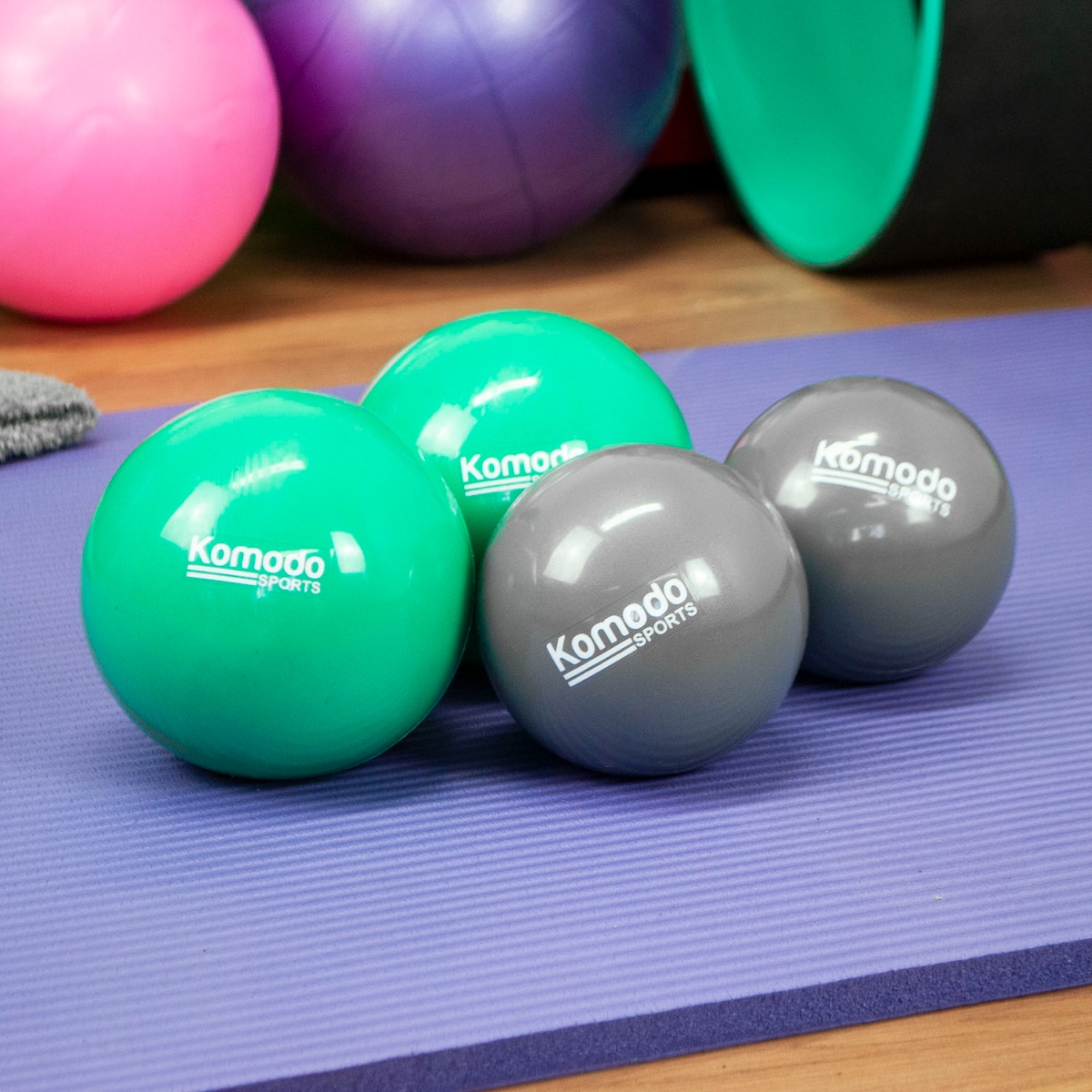 Pair of grey 1kg weighted balls made from PVC with a textured grip, designed for toning and exercise workouts